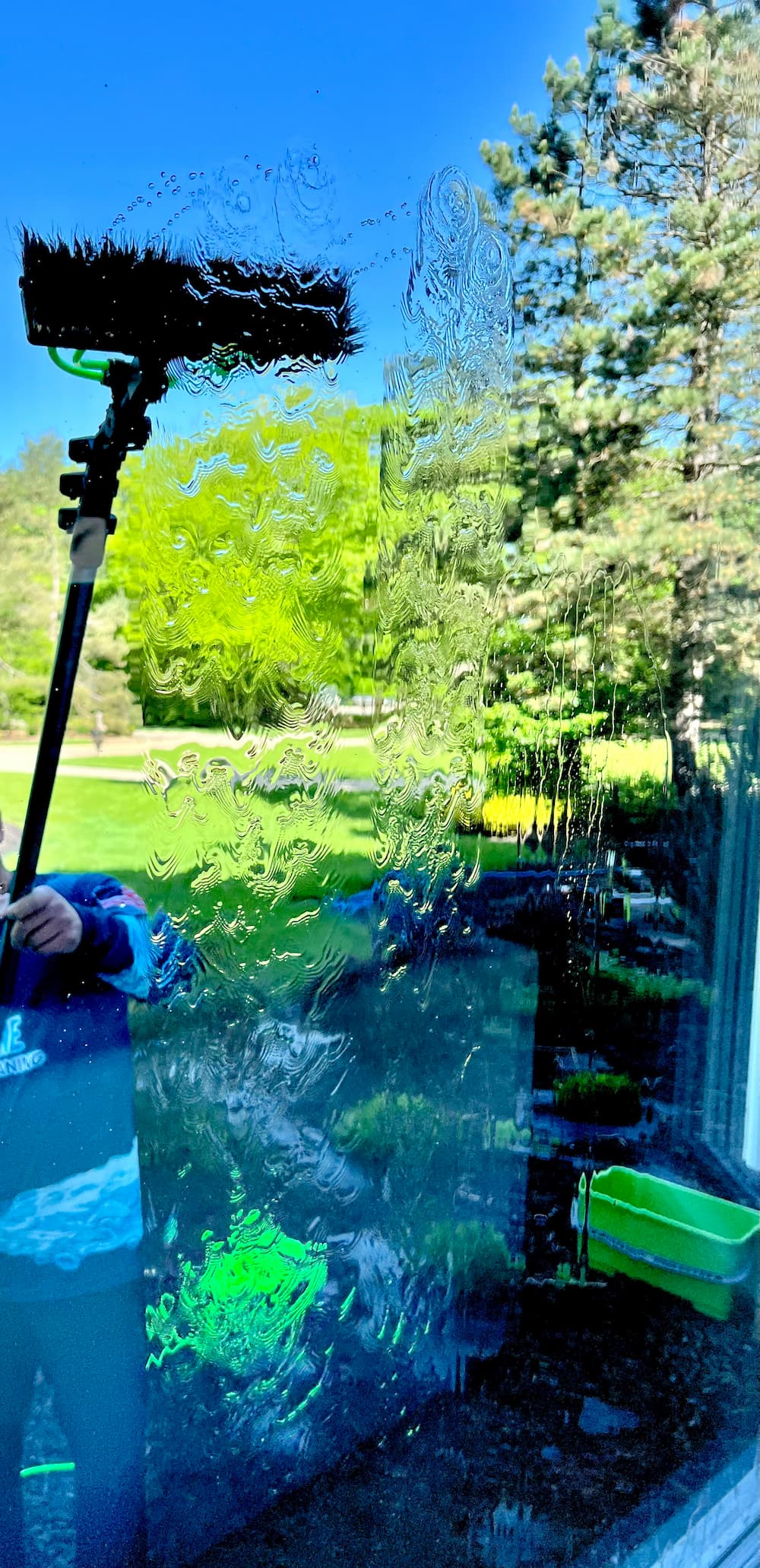 TruShine professional cleaning a window